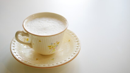 A cup of hot milk isolated on white background