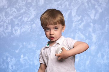 little boy holds a disposable cup of cornstarch in his hand. ecologically pure. replacing plastic...