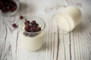 Homemade sweet yogurt with frozen berries in a glass