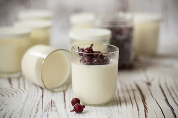 Homemade sweet yogurt with frozen berries in a glass