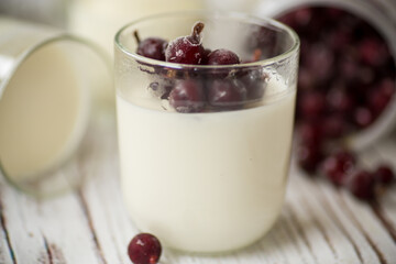 Homemade sweet yogurt with frozen berries in a glass