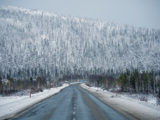 Snow pass. Winter Arctic road through the hills