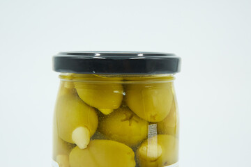 Canned green olives in a glass jar. Home canning.