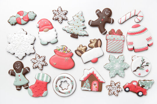 A big group of beautiflly decorated gingerbread cookies on  white background. Tasty homemade Christmas cookies close up view directly above.