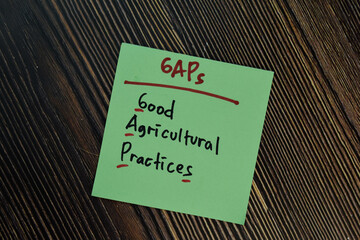 GAPs - Good Agricultural Practices write on a book isolated isolated on Wooden Table.