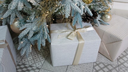 Fototapeta na wymiar New Year's gifts under the tree. Merry Christmas