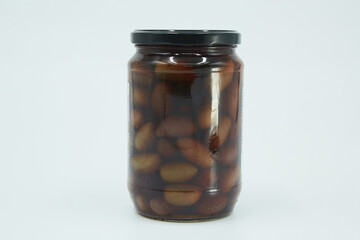 Canned black olives in a glass jar. Home canning.