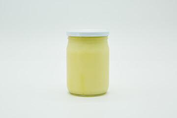 Canned white sauce, ghee, ghee, or fat in a glass jar. Home canning.