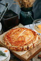 Puff pastry chicken pie with different fillings. Baking on a wooden background, close-up.