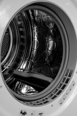 Modern washing machine with empty drum, closeup. High quality photo