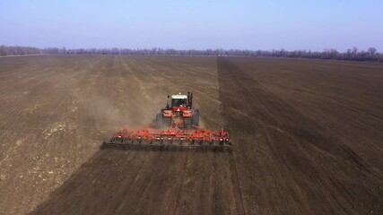 Agriculture. land cultivation. cultivator on a heavy tractor does pre-sowing soil cultivation
