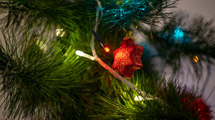 Christmas background. Spruce branches, light garlands and Christmas toys