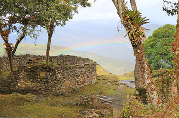 Ancient Stone Round House Ruins on the Hilltop Inside Kuelap Archaeological Complex with the Gorgeous Rainbow, Amazonas Region, Northern Peru