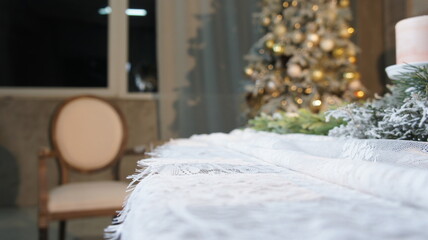 New Year's table, tablecloth, candles, coniferous branches
