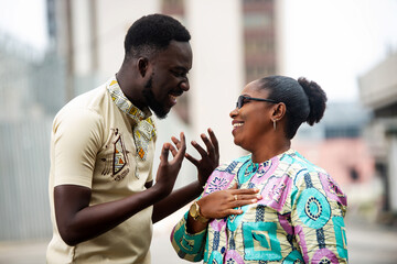 african adult couple talking together on the street
