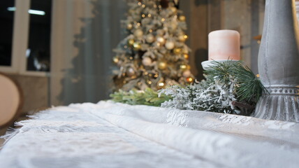 New Year's table, tablecloth, candles, coniferous branches