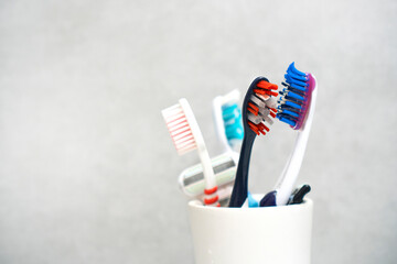 A glass with toothbrushes for all family