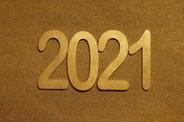 wooden golden numbers 2021 on sparkling gold background