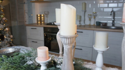 New Year's table, tablecloth, candles, coniferous branches