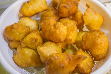 Pettole, typical fried dough from Southern Italy. They are made on the night of Santa Cecilia (22nd...