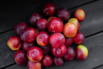 Ripe cherry plum on wooden background