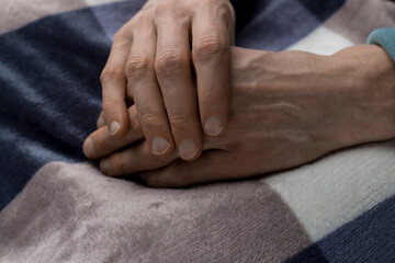 Close-up of the hands of an old sick man.