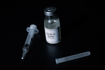 covid 19 corona virus cure vaccine injector syringe black background