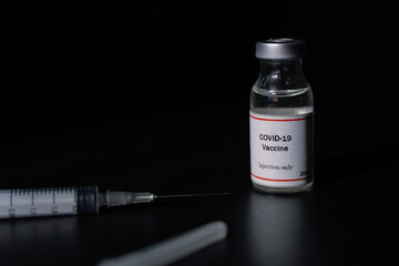 covid 19 corona virus cure vaccine injector syringe black background