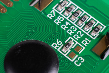 Macro shot of circuit board with resistors microchips and electronic components. Integrated communication processor. Information engineering.