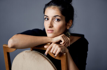 Fototapeta premium elegant lady in black dress makeup model earrings interior