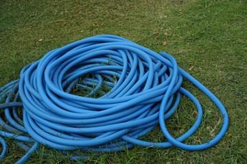 blue Water hose on the lawn in the garden