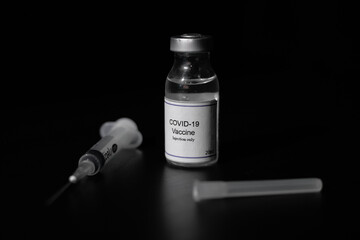 covid 19 corona virus cure vaccine injector syringe black background