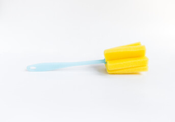 Yellow sponge bottle cleaner on white background, simple cleaning tool in the kitchen