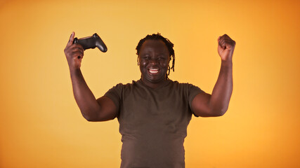 Fototapeta premium African american black man playing video games and winning. Isolated. High quality photo