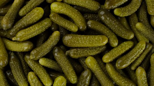 Pickled gherkins cucumbers top view rotate