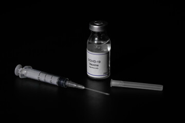 covid 19 corona virus cure vaccine injector syringe black background