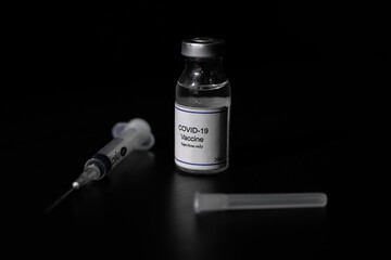 covid 19 corona virus cure vaccine injector syringe black background