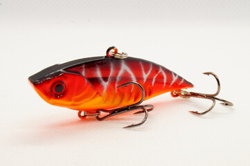 Fishing bait. Red Wobbler close-up on a light background