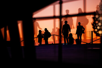 Silhouettes of people waiting in the airport for delayed or cancelled flights because of Corona virus, coming home for Christmas in 2020