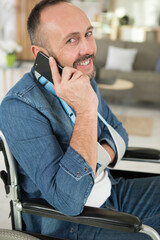 man in wheelchair talking on phone