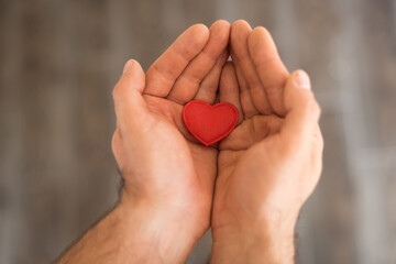 Top view of decorative red heart in man hands ,Valentines day concept, romantic concept, world health day concept.Love