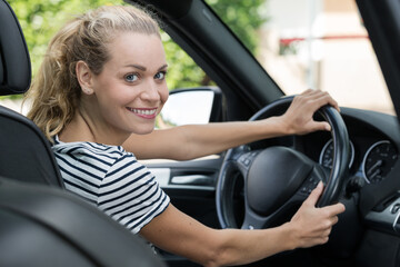Fototapeta na wymiar beautiful happy woman driving her car