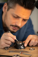 close up of watchmaker repairing a watch