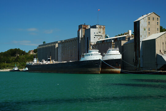 Two tankers docked by a grain elevator in Goderich