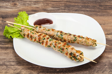 Minced pork skewer kebab with sauce