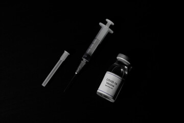 covid 19 corona virus cure treatment vaccine with syringe black background