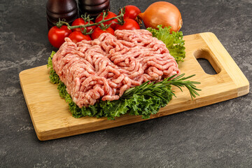 Raw pork minced meat over board