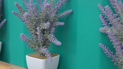Purple flowers in a pot. Artificial flowers