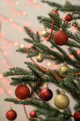 Part of red and gold decorated Christmas tree on the light bokeh backgrount