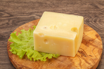 Emmental cheese over wooden board
